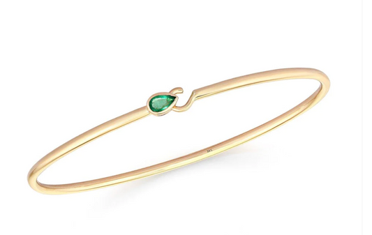 Gold bangle with green stone