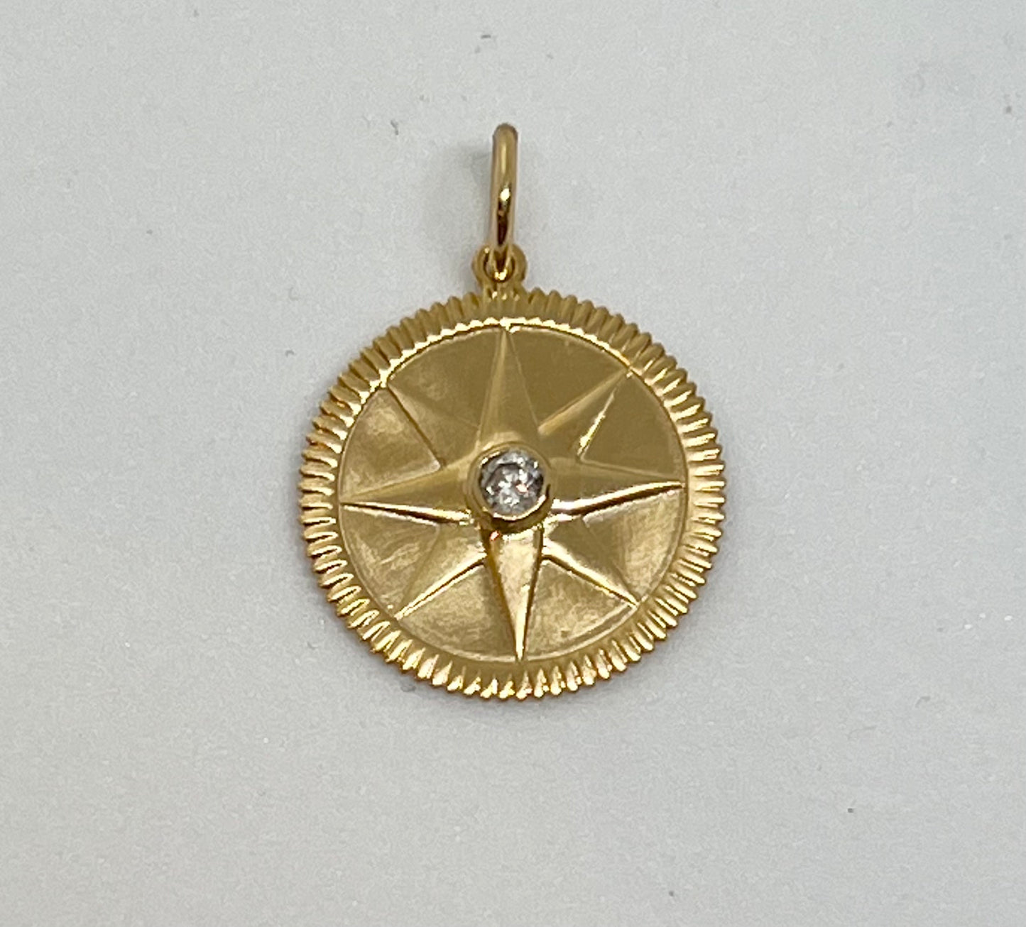 Gold and diamond compass star medallion